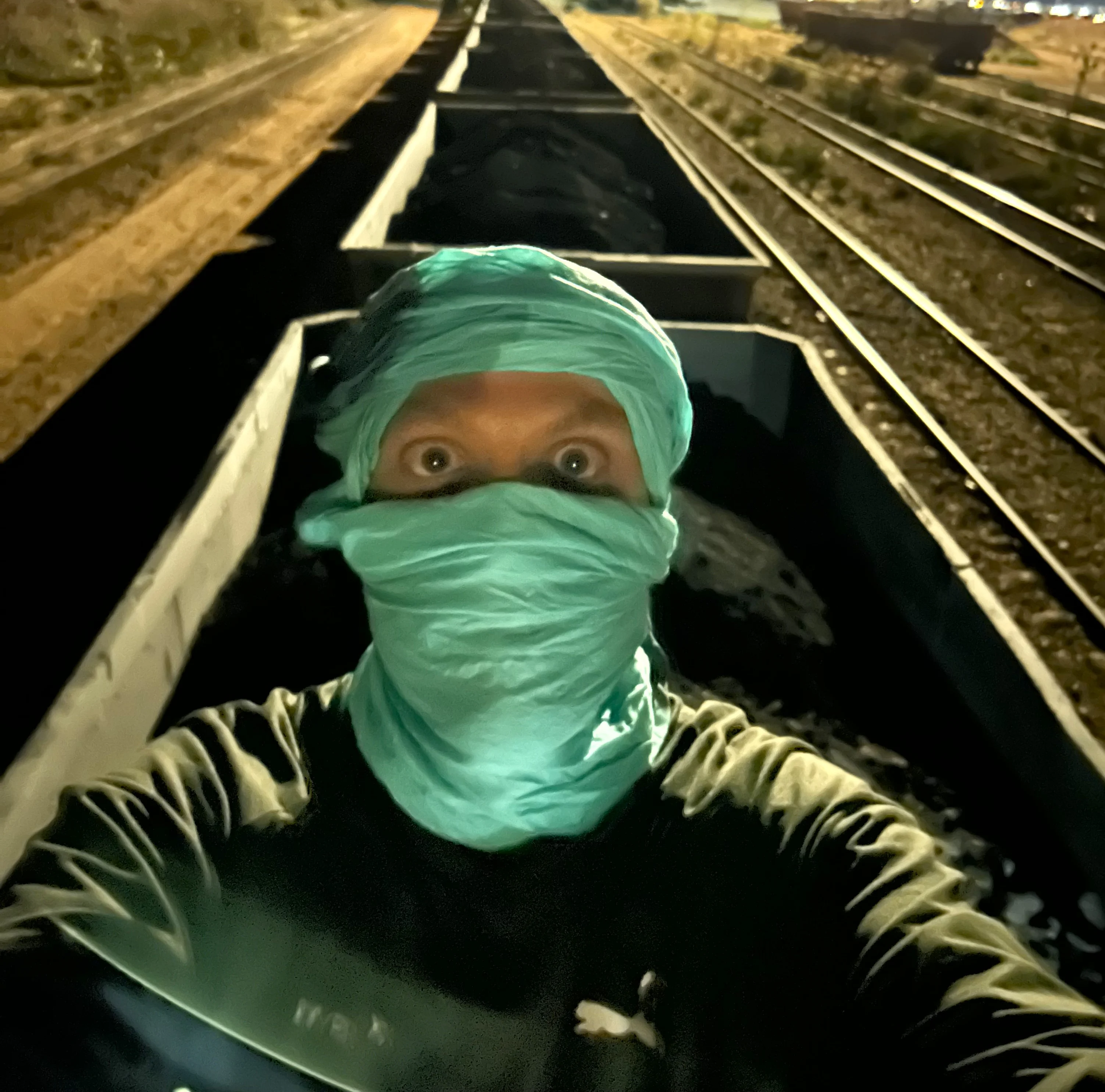 Persona preparada para viajar sobre los vagones del Tren de Hierro de Mauritania, cubierta para protegerse del polvo